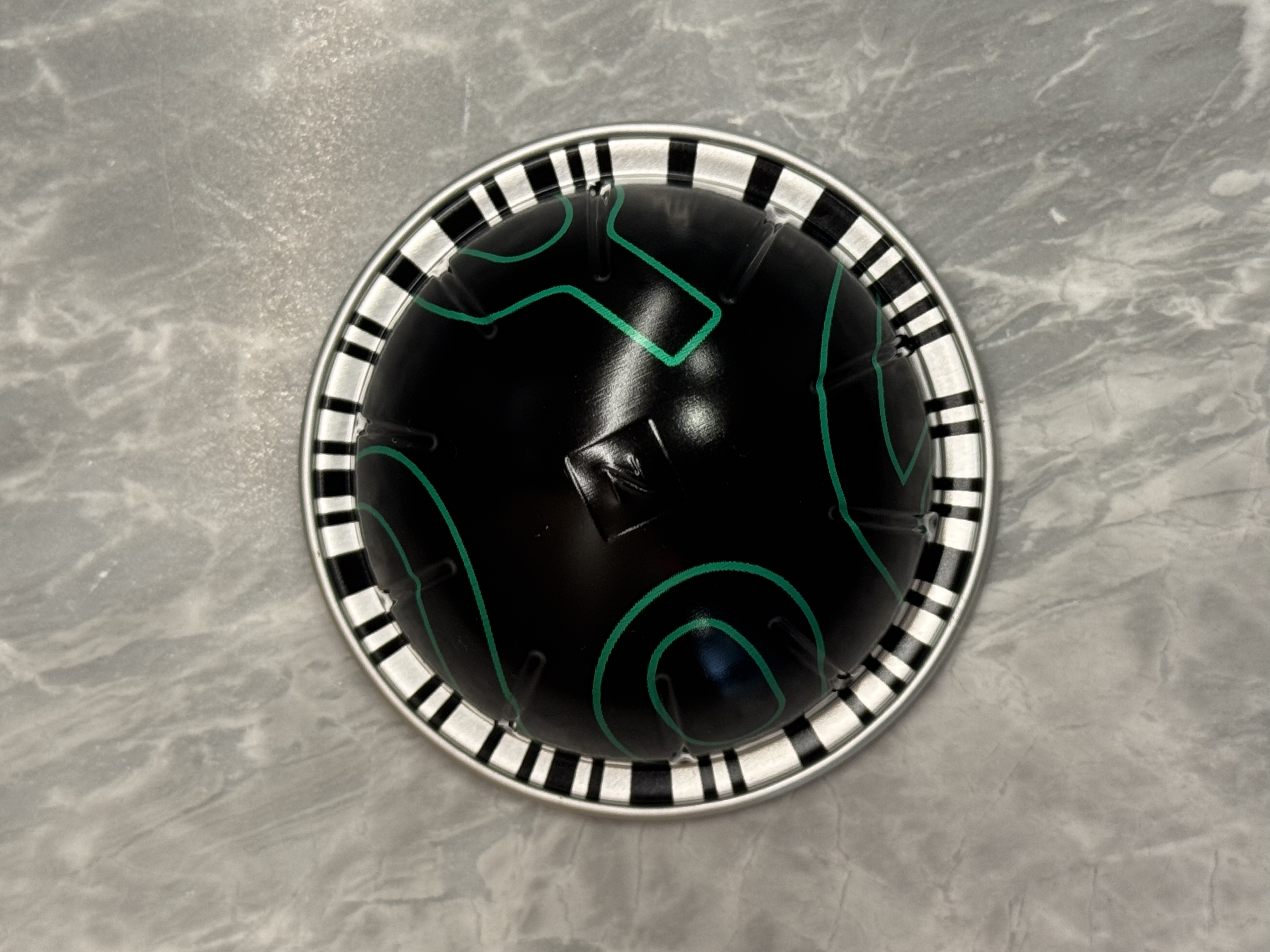 Nespresso Vertuo pod — barcode ring visible around the rim styled-image